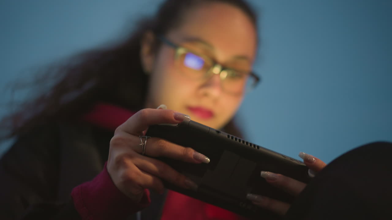 Female Coder Testing, Female Software Engineer Analyzing Mobile App Display Late At Night, Young Woman Programmer Testing Application Interface On Portable Device With Reflected Light At Night