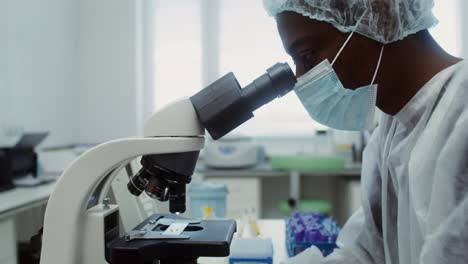 scientist using a microscope in a laboratory