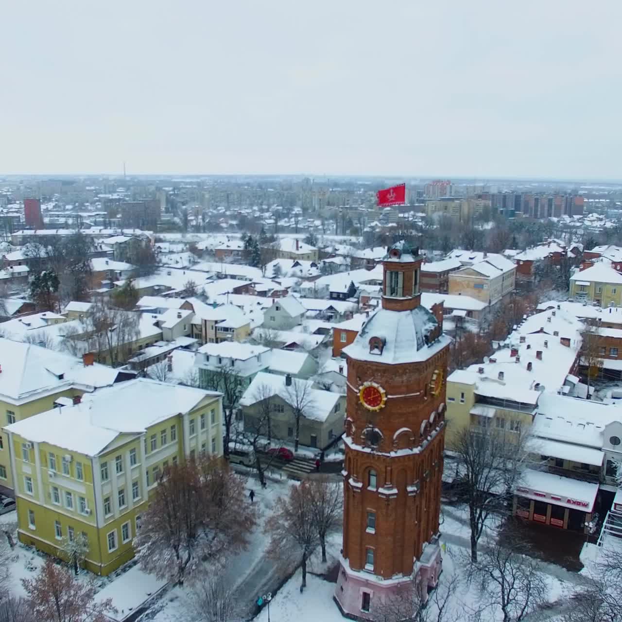 High old brick water tower in the downtown of Vinnytsia, Ukraine. City view on winter snowy daytime. Top view