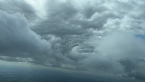 impresionante vista desde un jet caín mientras volaba cerca del fondo de una enorme nube de tormenta en una curva a la izquierda para evitar