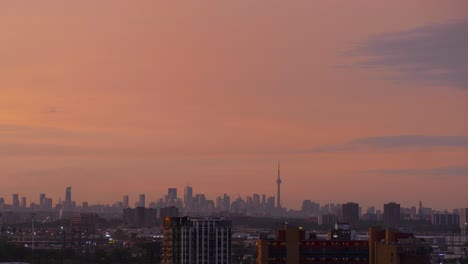 toronto cityscape time lapse from dark to daylight, urban architecture and beautiful pink orange sunset