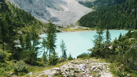 flying with drone above the lake in the italian alps
