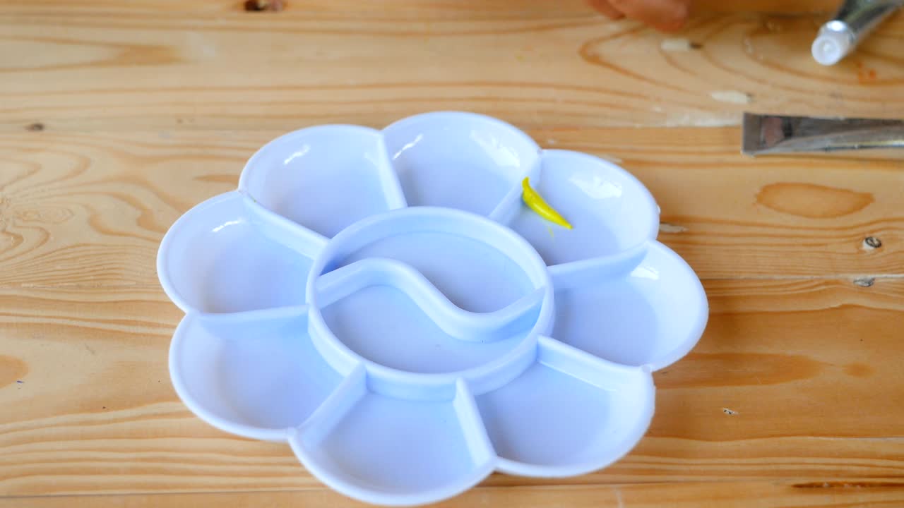 아이는 색 패에 노란색을 떨어뜨립니다.