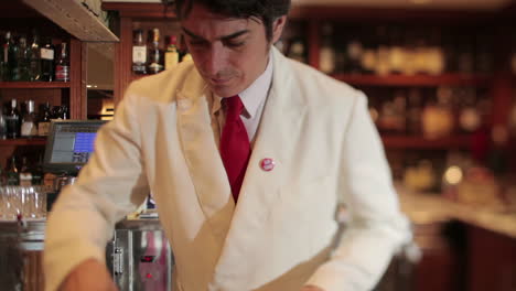 stylish waiter in cocktail bar