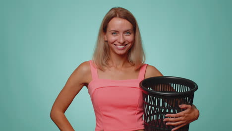 smiling woman taking off, throwing out glasses into bin after vision laser treatment therapy