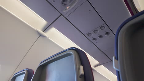 aircraft cabin ceiling - view of an aircraft cabin ceiling featuring air vents and overhead compartments, with a focus on inflight amenities