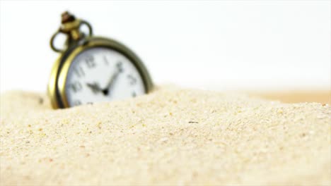 Alarm-clock-in-sand