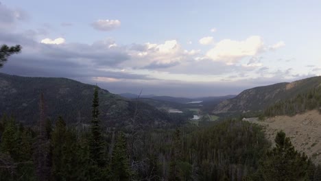 Aerial-Flying-Through-Green-Forest-Opening-Up-to-Valley-of-Trees,-Colorado-Aerial-of-Mountain-Landscapes,-Boulder-County-Aerial-Nature