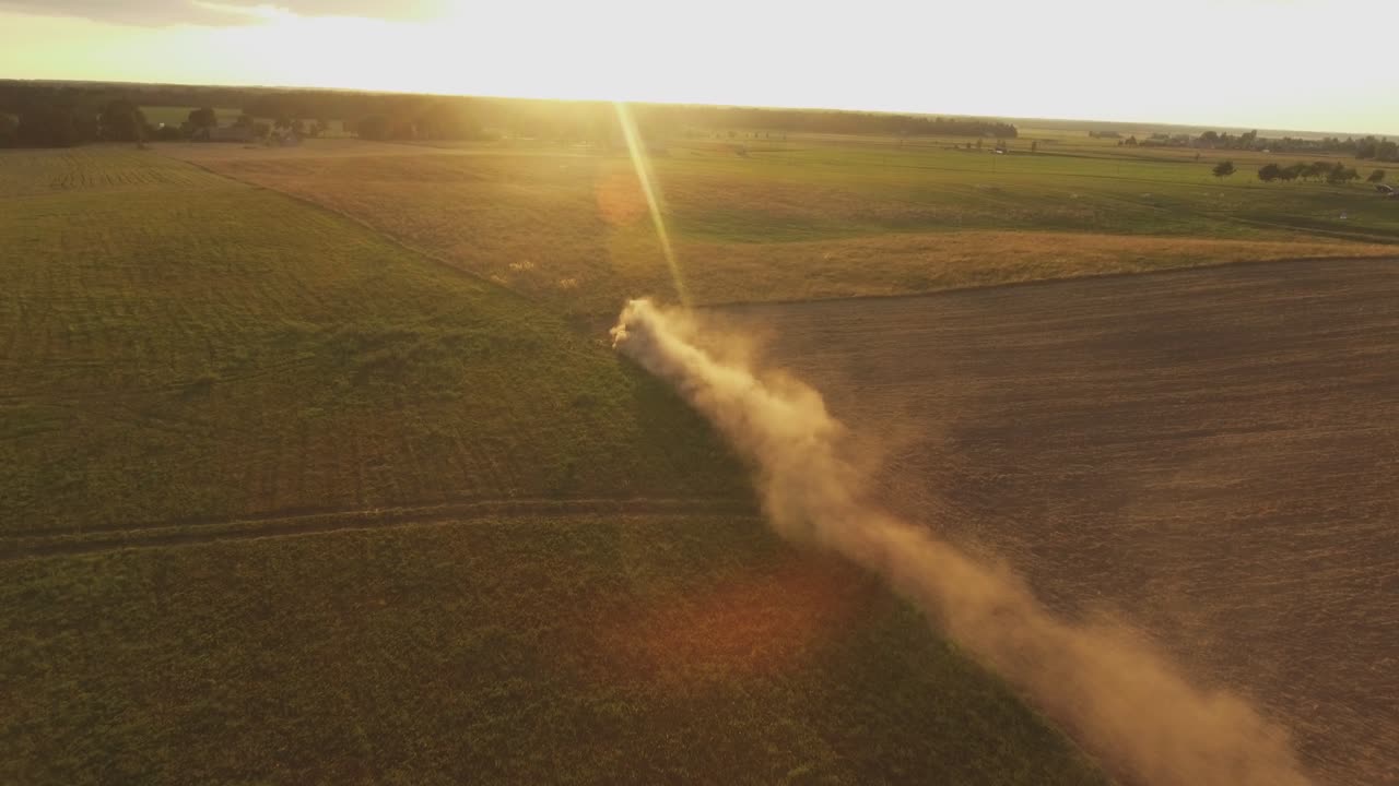 Heavy Agricultural Machinery With Implements In Agricultural Fields On A Sunny Summer Evening. Aerial Dolly-In Pedestal-Down Active-Track Footage