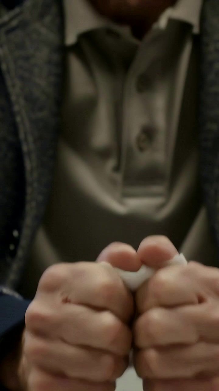 Vertical video: Picking up senior man crumpling white tissues at table, calming nerves