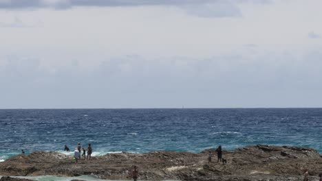 visitors explore and enjoy a rocky seaside landscape