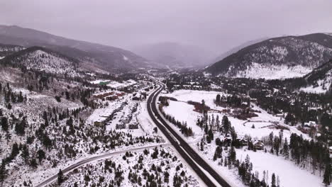 cinematic colorado aerial drone winter december christmas summit cove keystone ski resort epic local pass entrance rocky mountains i70 breckenridge vail summit county high country backwards motion