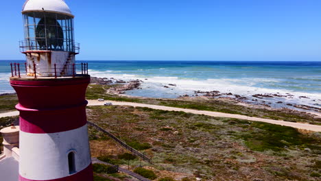 drone pullback past old cape agulhas lighthouse on southernmost tip of africa