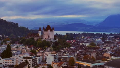 Aerial cinematic drone downtown Thun Switzerland cars Swiss village city downtown stunning Thun Castle Dukes of Z&auml;hrigen Interlocken Bern Jungfrau cloudy sunrise sunset forward movement