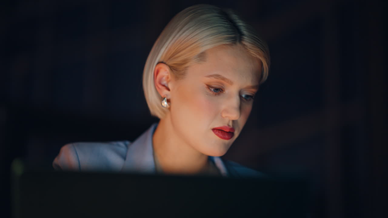 Portrait manager working late evening at dark apartment. Blonde sipping coffee