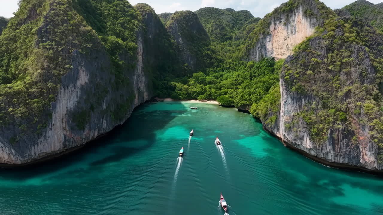 Aerial View of Longtail Boats in a Tropical Bay Surrounded by Lush Cliffs