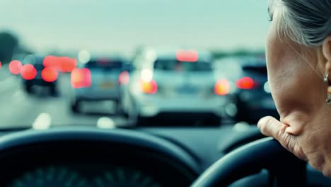 a woman driving a car in traffic