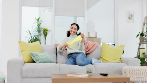 headphones, music and woman on sofa after cleaning