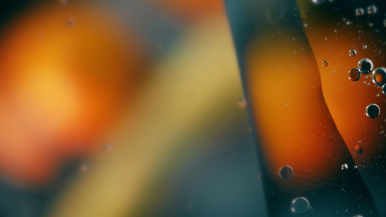 A drop of oil floating on water. Abstract warm bubble background.