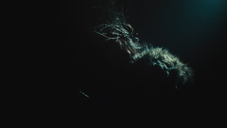 a creepy witch stands in the moody pose during the night storm