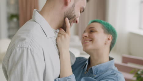 close up of a loving young couple hugging and tenderly looking at each other at home 1