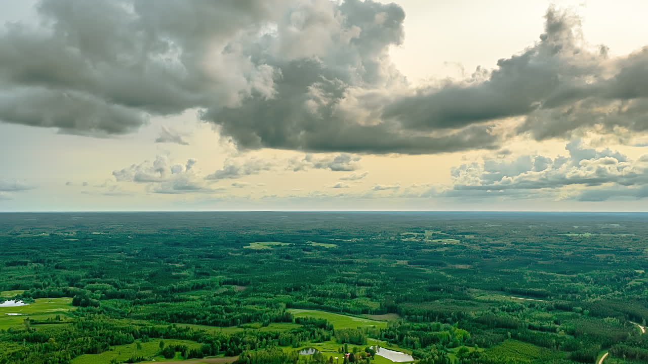 Dramatic storm clouds shifting over forested region in fast paced timelapse pullback motion