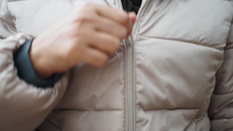 close-up of a zipper on a white puffer jacket