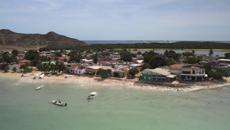 Aerial-shot-of-Mar-de-Fondo-on-Isla-Gran-Roque-with-clear-waters-and-boats