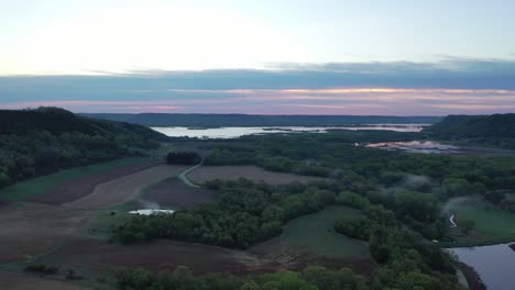 sunrise/sunset over river valley with farmland and forest