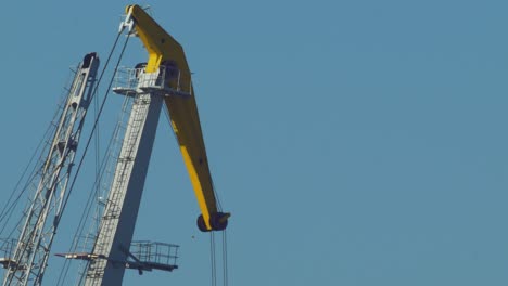 sea port crane in sunny, warm day, telephoto medium closeup shot from distance