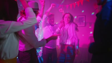 en la fiesta del club: grupo diverso de amigos se divierten, bailan, saltan, socializan y beben. gente joven elegante clubbing. discoteca luces de neón.