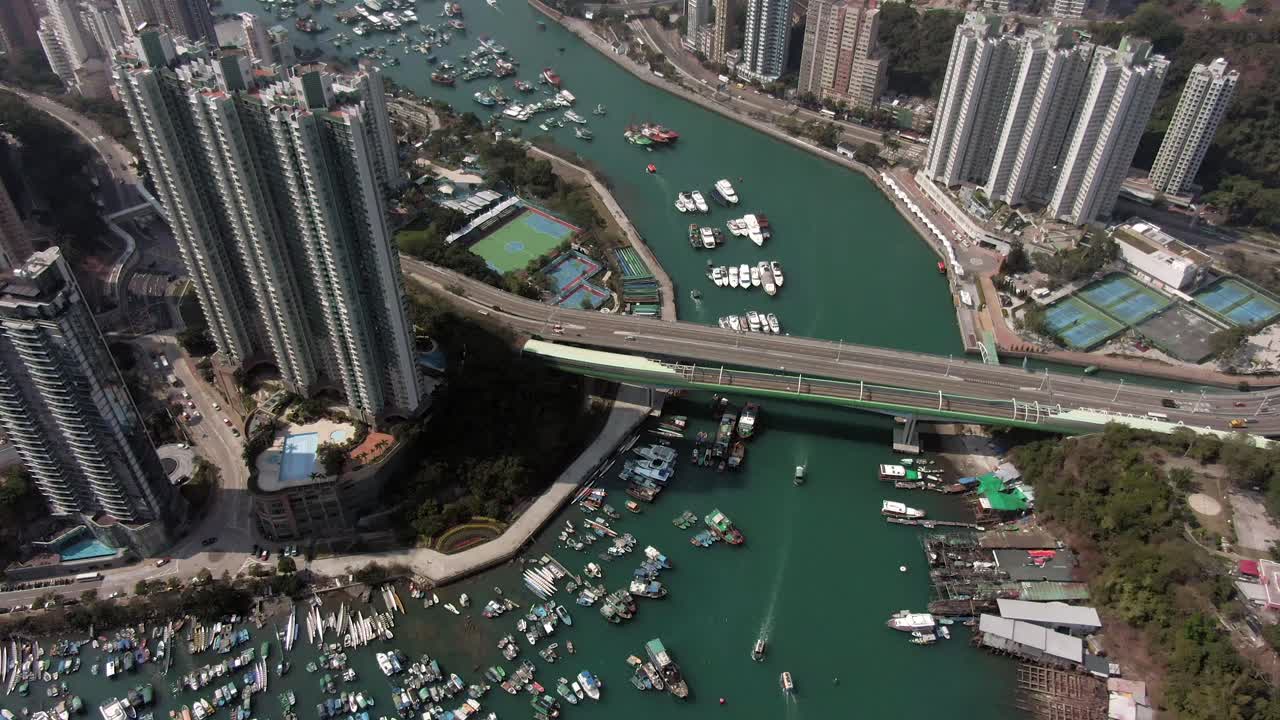 Aerial View of Hong Kong Harbor with Boats, Buildings, and Bridge