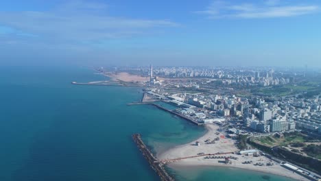 israel skyline from a drone. panoramic aerial view above coastline of tel aviv modern and business city with hotels, seashore and beach. middle east skylines