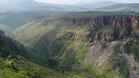 aerial panorama shot of green canyon with cloud shadow move on the mountains cliff on the sides