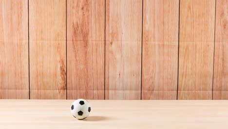 una pelota de fútbol se mueve a través de un estante de madera