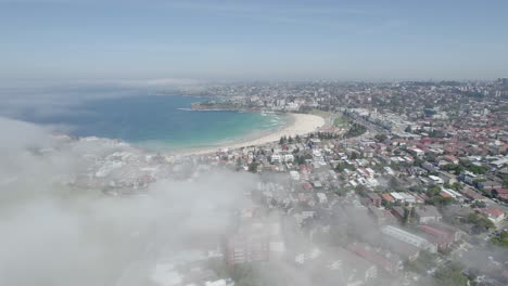 Flying-Over-Sea-Fogs-Swept-Over-Eastern-Suburbs-In-The-Iconic-Bondi-Beach,-Sydney,-Australia