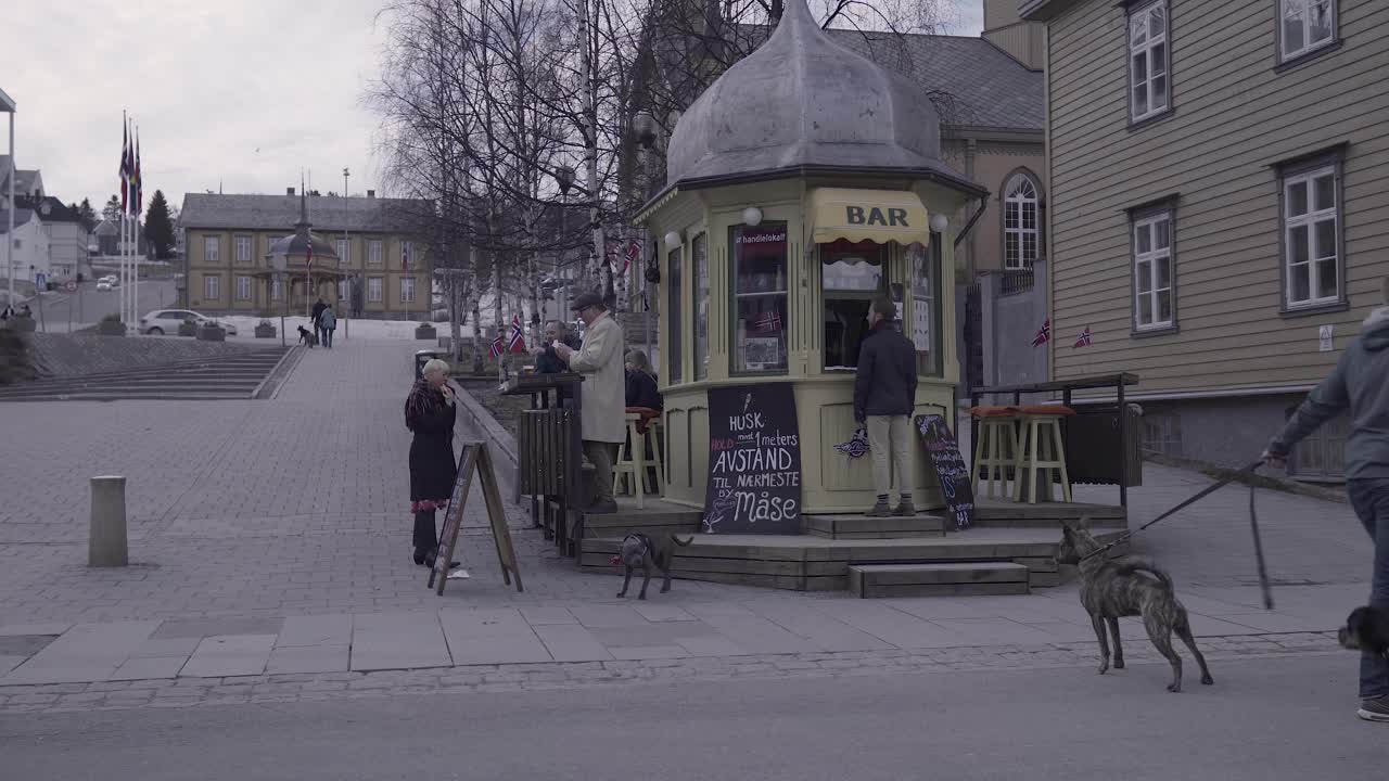 Famous old bar from Tromso with people outside.