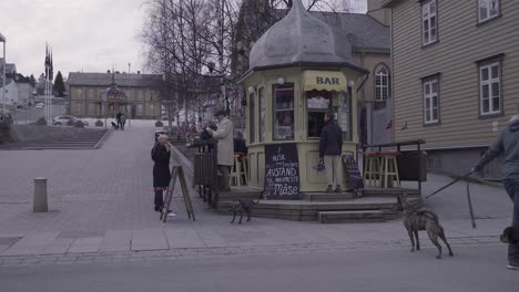 famous old bar from tromso with people outside.