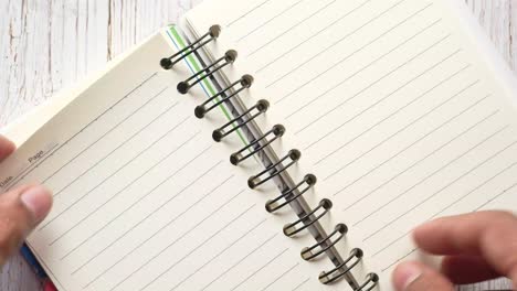 open spiral-bound notebook on wooden table