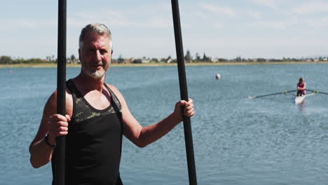 portrait of senior caucasian man standing by a river