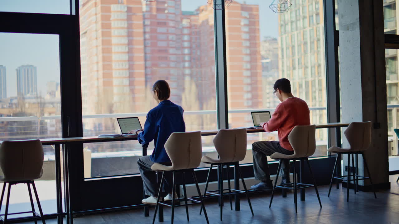 Professional startupers planning project at modern coworking space back view