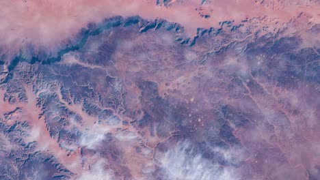flying over the earth on the iss. flying over desert, aerial view from space.