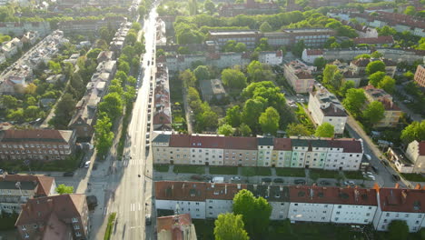 panorama of buildings with green trees on asunny day with empty street during pandemic in gdansk, poland