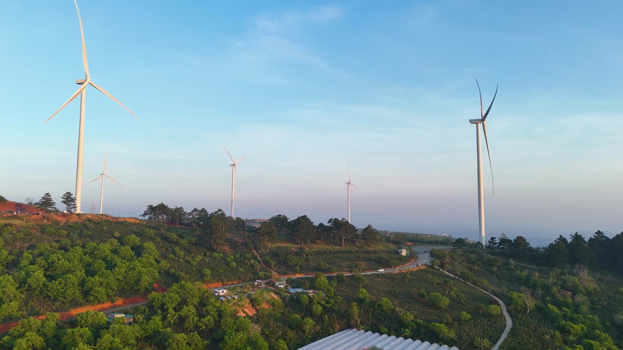 Wind power hill with rotating blades in the morning sunlight in Da Lat - Vietnam | Wind power