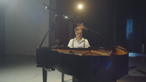 virtuoso pianist playing grand piano in concert hall