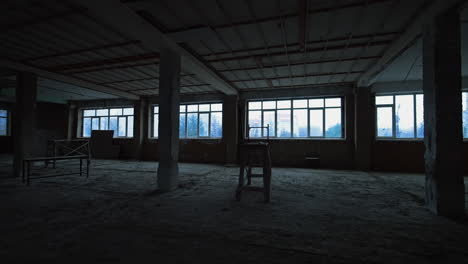 spacious premise in the unfinished building. some scaffolds are in the room with big windows.