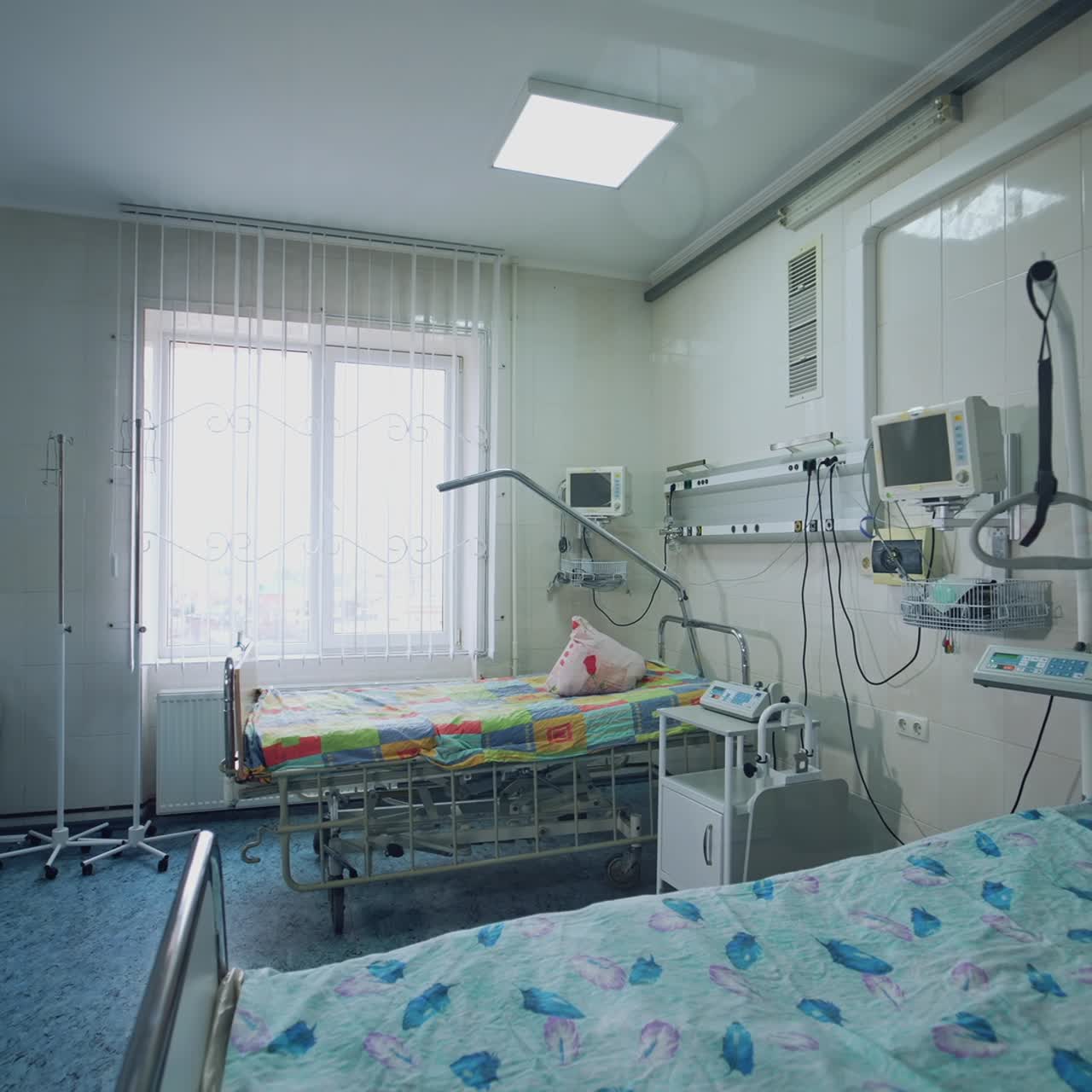 Modern hospital room with two beds. Intensive care unit. Empty clean reanimation room with new medical equipment. View from the hospital corridor