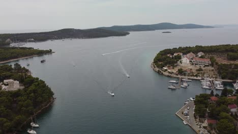 cinematic drone shot of sea traffic with boats coming back to milna port, brac island, croatia