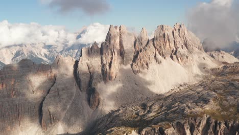 aerial view of croda da lago mountain, with clouds and blue sky