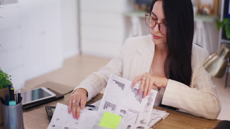 successful businesswoman analyzing financial report in office